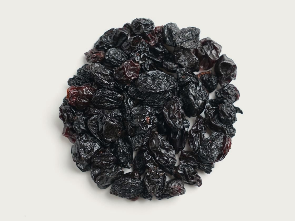 A pile of red Flame raisins, deep reddish brown, photographed from above.